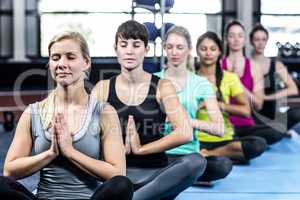 Fitness class doing yoga exercises