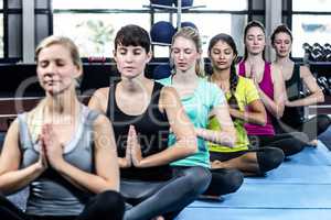 Fitness class doing yoga exercises