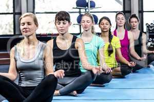 Fitness class doing yoga exercises