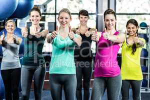 Fit smiling group with thumbs up