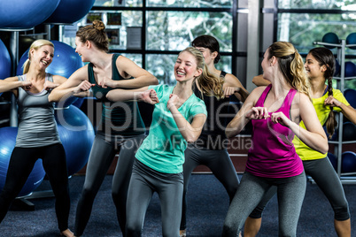 Fit group dancing and smiling