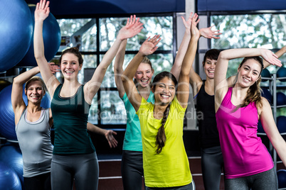 Fit group dancing and smiling