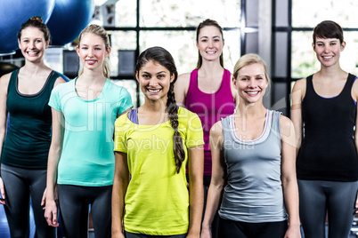 Fit smiling group standing straight