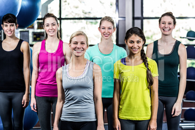 Fit smiling group standing straight