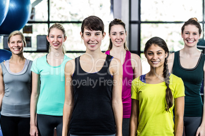 Fit smiling group standing straight