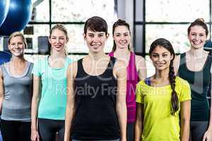 Fit smiling group standing straight