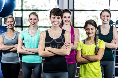 Fit smiling group with arms crossed