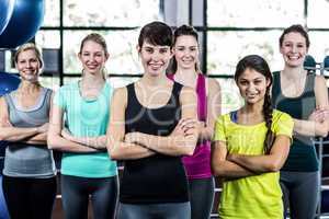 Fit smiling group with arms crossed