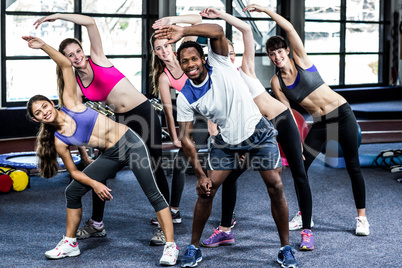 Fit smiling group doing exercise