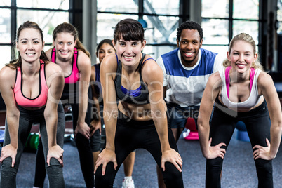 Fit group with hands on knee