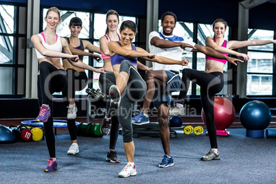 Fit smiling group doing exercise