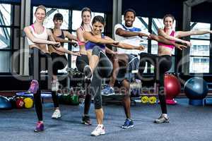 Fit smiling group doing exercise