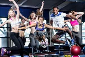 Fit group smiling and jumping