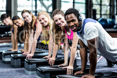 Group of fit people doing some push ups