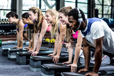 Group of fit people doing some push ups