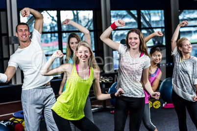 Fit group dancing and smiling