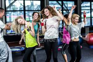 Fit group dancing and smiling