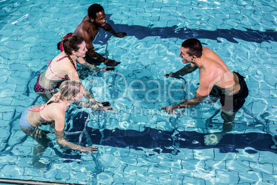 Fitness class doing aqua aerobics on exercise bikes