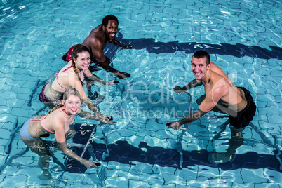 Fitness class doing aqua aerobics on exercise bikes