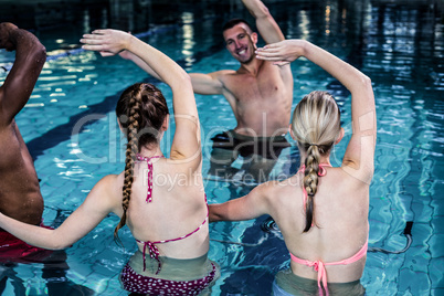 Fit people doing an aqua aerobics class