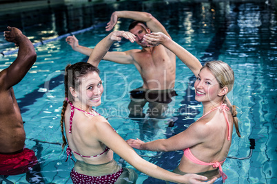 Fit people doing an aqua aerobics class