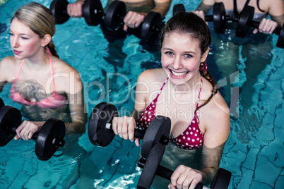 Fit people doing an aqua aerobics class