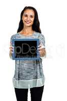 Portrait of smiling woman showing tablet screen