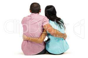 Rear view of couple hugging sitting