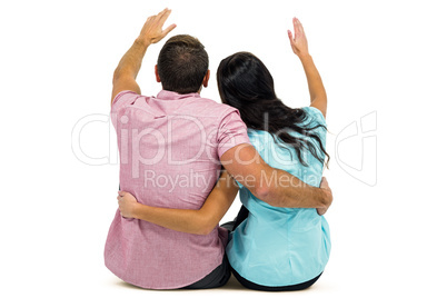 Rear view of couple with arm around