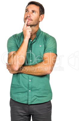 Thoughtful man with finger on lips looking away