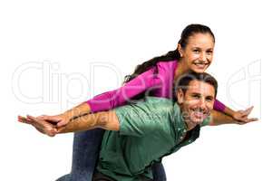 Happy man giving piggy back to his girlfriend