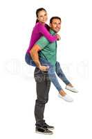 Smiling couple giving piggy back