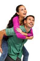 Smiling man giving piggy back to his girlfriend