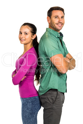Couple standing back to back and smiling at the camera