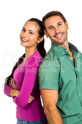 Couple standing back to back looking at camera