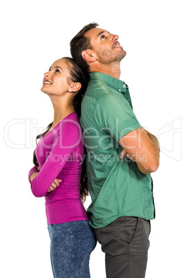 Couple standing back to back land looking up