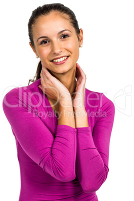 Smiling woman with hands on neck looking at the camera