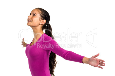 Smiling woman with arms outstretched looking up