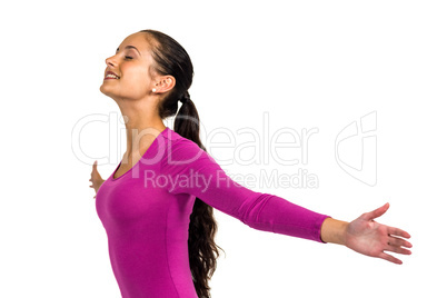 Smiling woman with arms outstretched with eyes closed