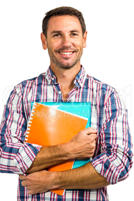 Smiling man standing holding notepads
