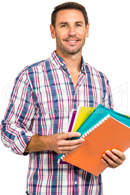 Confident man standing holding notepads