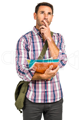 Thoughtful man standing and holding notepads