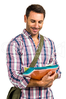 Smiling man standing with notepads