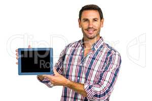 Young man showing tablet screen at camera