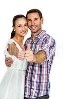 Young couple showing thumbs up at camera