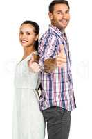 Smiling couple standing back to back showing thumbs up