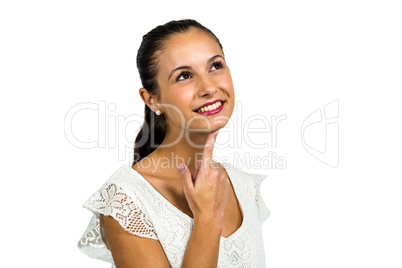 Smiling thoughtful woman with finger on chin