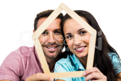 Young couple holding house shape