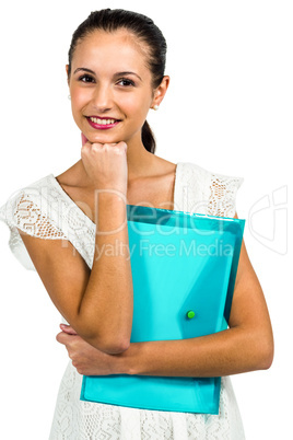 Smiling woman holding plastic holder with fist on chin