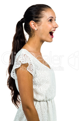 Surprised young woman with open mouth looking up